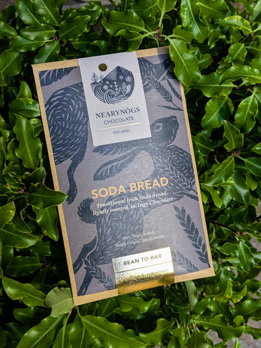 A chocolate bar packaging with 'SODA BREAD' text and an image of a chocolate bar with green leaves in the background.
